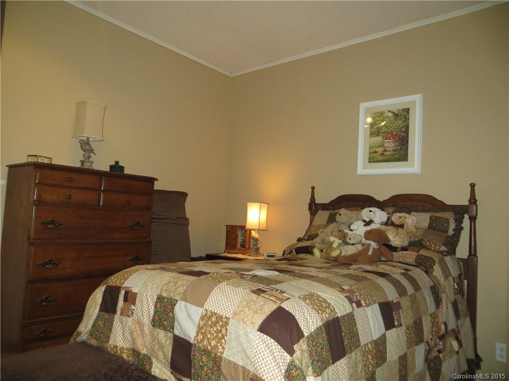 732 Ike Lynch Road Dallas, NC 28034 - Photo 18 of 24 a bedroom with a bed and a lamp on dresser