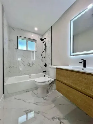 a bathroom with a toilet a sink and bathtub