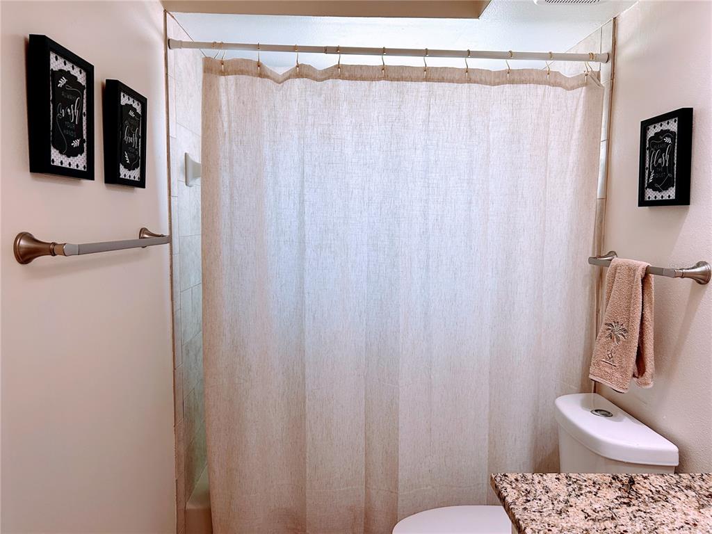6029 Wyoming Avenue New Port Richey, FL 34653 - Photo 12 of 14 a bathroom with a shower curtain and a sink