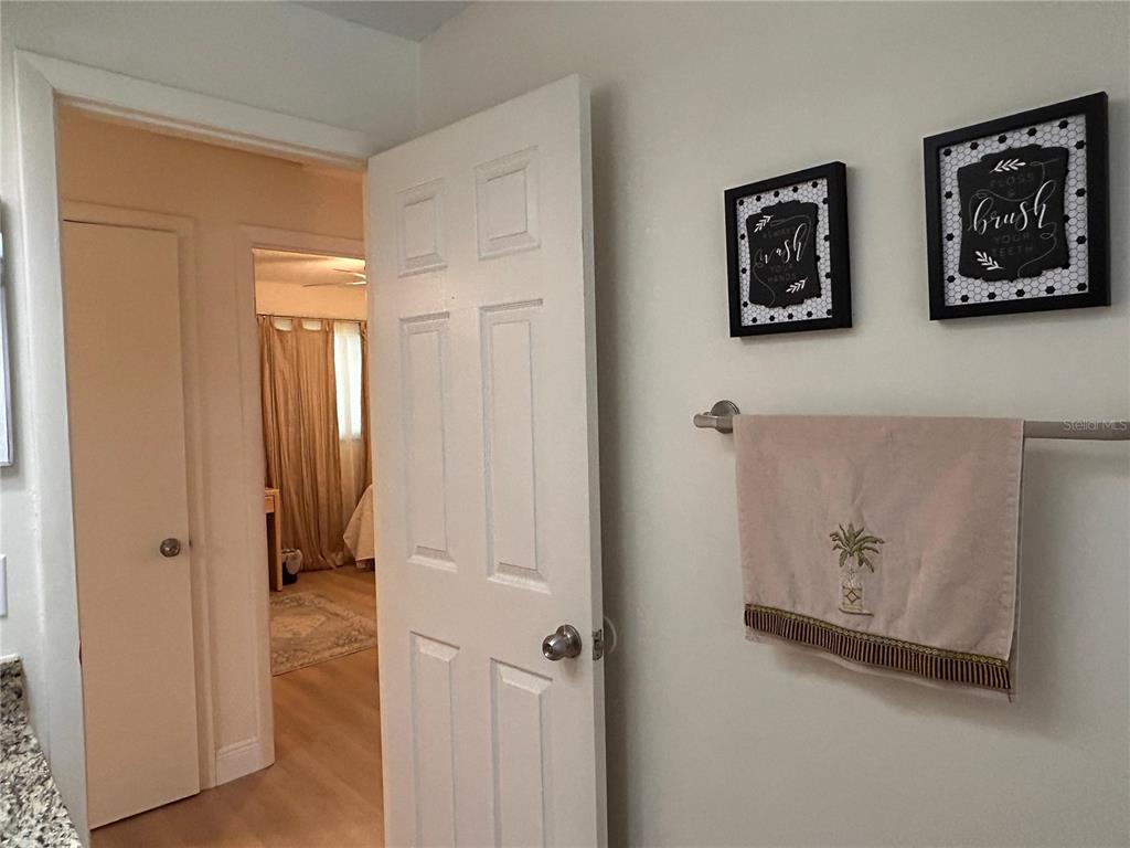 6029 Wyoming Avenue New Port Richey, FL 34653 - Photo 13 of 14 a view of a hallway with paintings on the wall