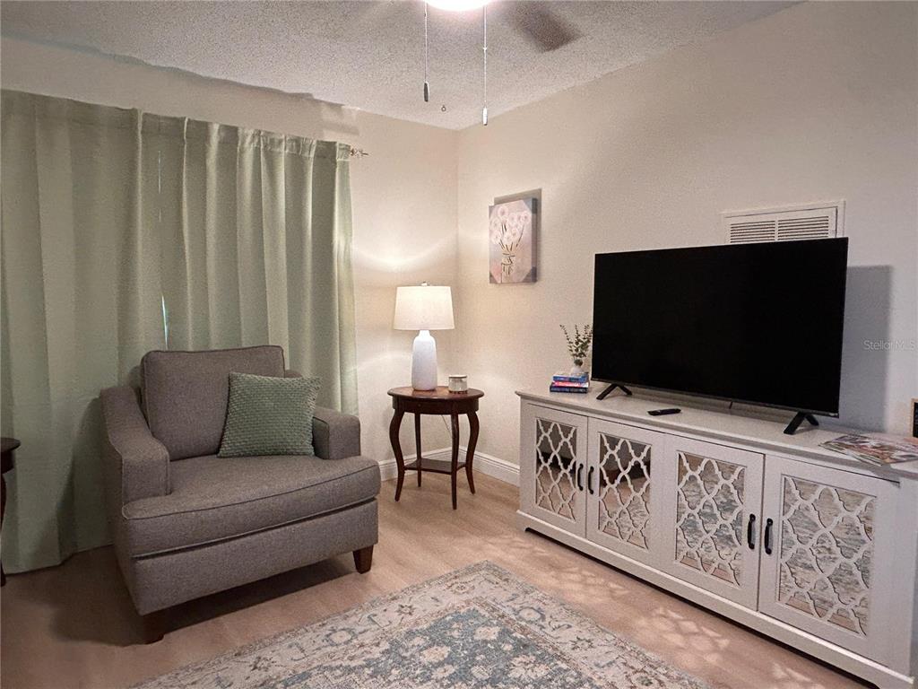 6029 Wyoming Avenue New Port Richey, FL 34653 - Photo 3 of 14 a living room with furniture and a flat screen tv
