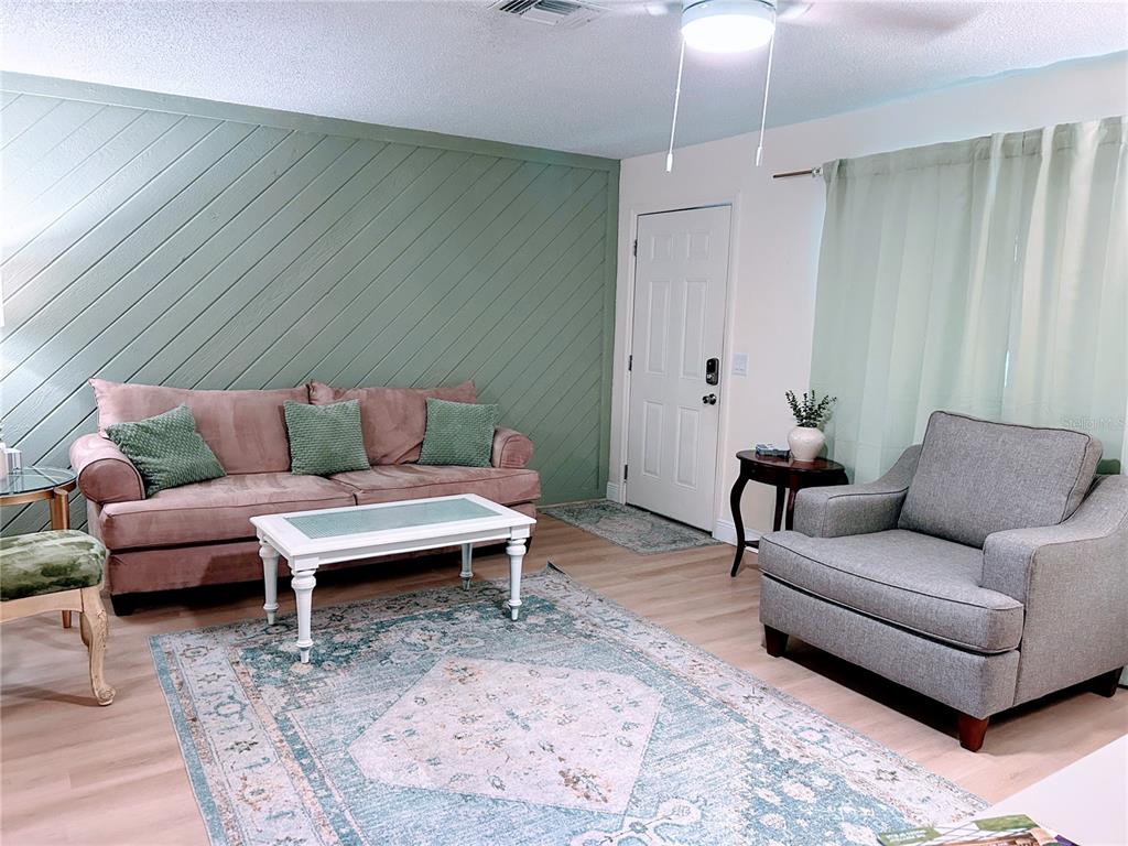 6029 Wyoming Avenue New Port Richey, FL 34653 - Photo 4 of 14 a living room with furniture and a rug