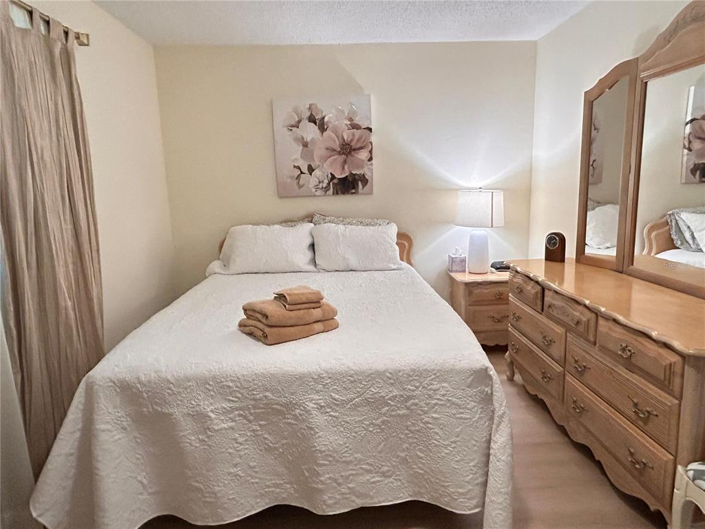 6029 Wyoming Avenue New Port Richey, FL 34653 - Photo 8 of 14 a bedroom with a bed and a large mirror