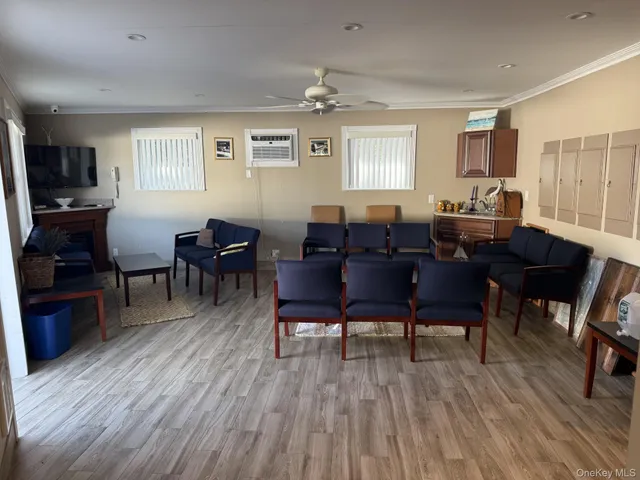 a view of a livingroom with furniture window and wooden floor