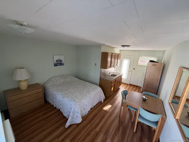 a bedroom with furniture and wooden floor