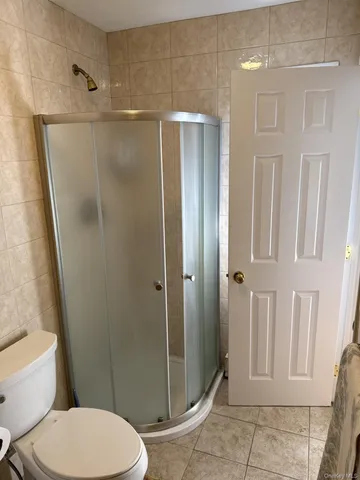 a bathroom with a toilet and a shower