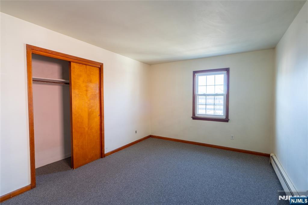24 Mahar Avenue Clifton, NJ 07011 - Photo 17 of 20 an empty room with windows and closet
