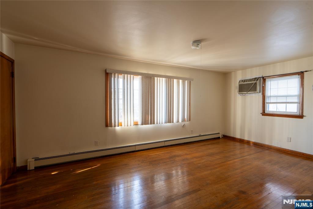 24 Mahar Avenue Clifton, NJ 07011 - Photo 6 of 20 an empty room with wooden floor and windows