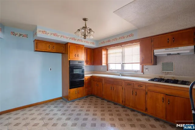 a bedroom with stainless steel appliances granite countertop a sink and a refrigerator