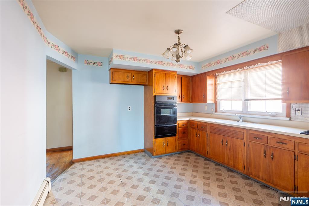 24 Mahar Avenue Clifton, NJ 07011 - Photo 9 of 20 a bedroom with stainless steel appliances granite countertop a sink and a refrigerator