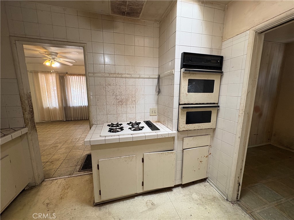 14023 Studebaker Road Norwalk, CA 90650 - Photo 12 of 33 a kitchen with a stove and a refrigerator