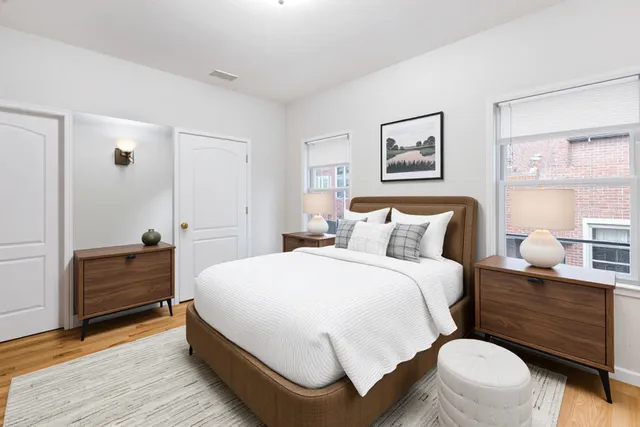 a spacious bedroom with a bed and a table