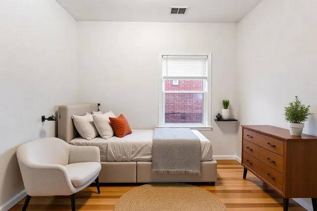 a bedroom with a bed and a dresser