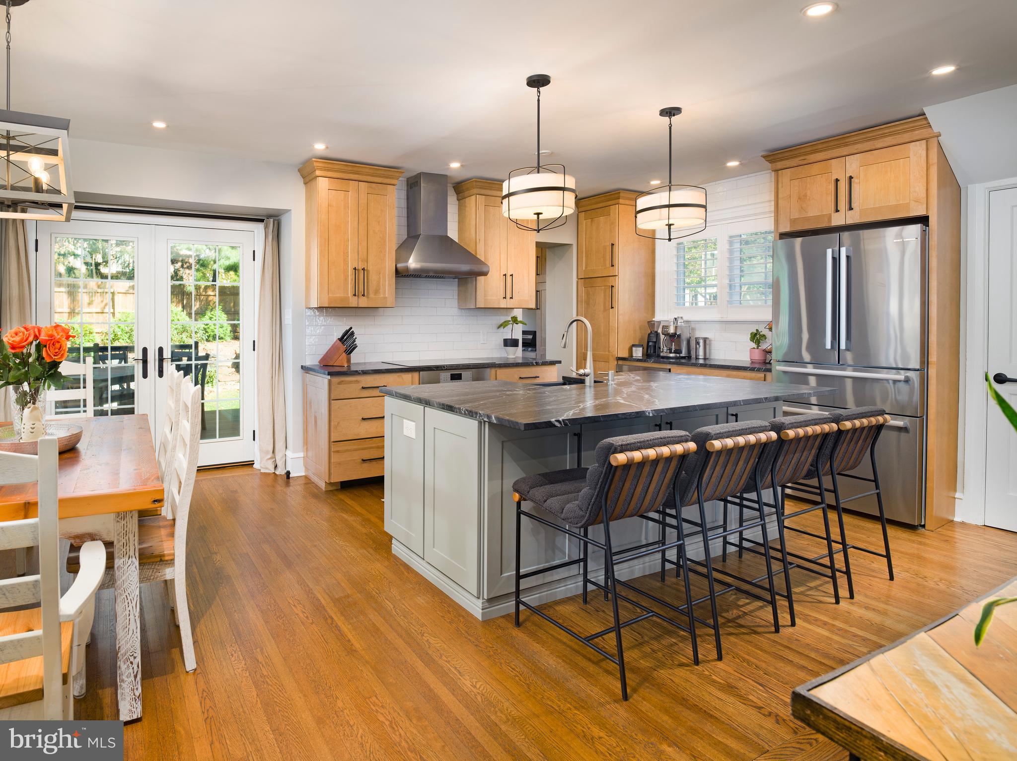 11 Shirley Road Narberth, PA 19072 - Photo 16 of 44 a kitchen with stainless steel appliances a dining table chairs stove refrigerator and cabinets