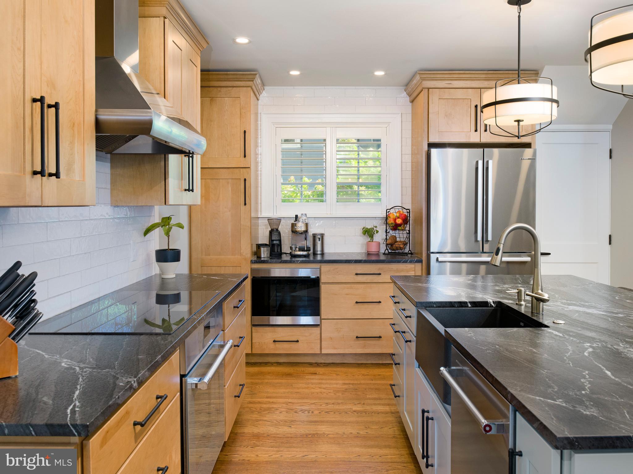 11 Shirley Road Narberth, PA 19072 - Photo 18 of 44 a kitchen with stainless steel appliances granite countertop a sink a stove and a wooden cabinets