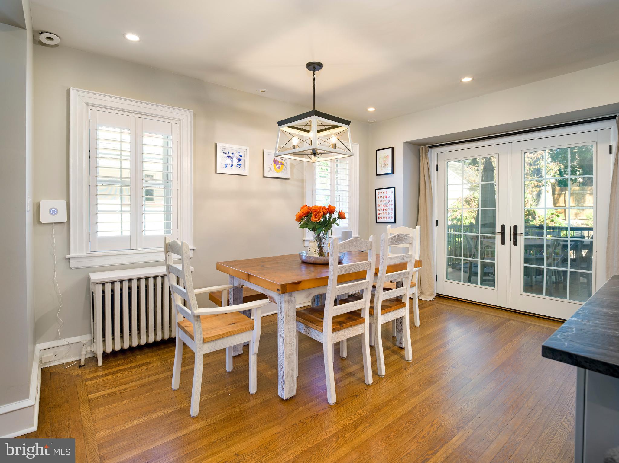 11 Shirley Road Narberth, PA 19072 - Photo 19 of 44 a dining room with wooden floor a chandelier a glass table and chairs