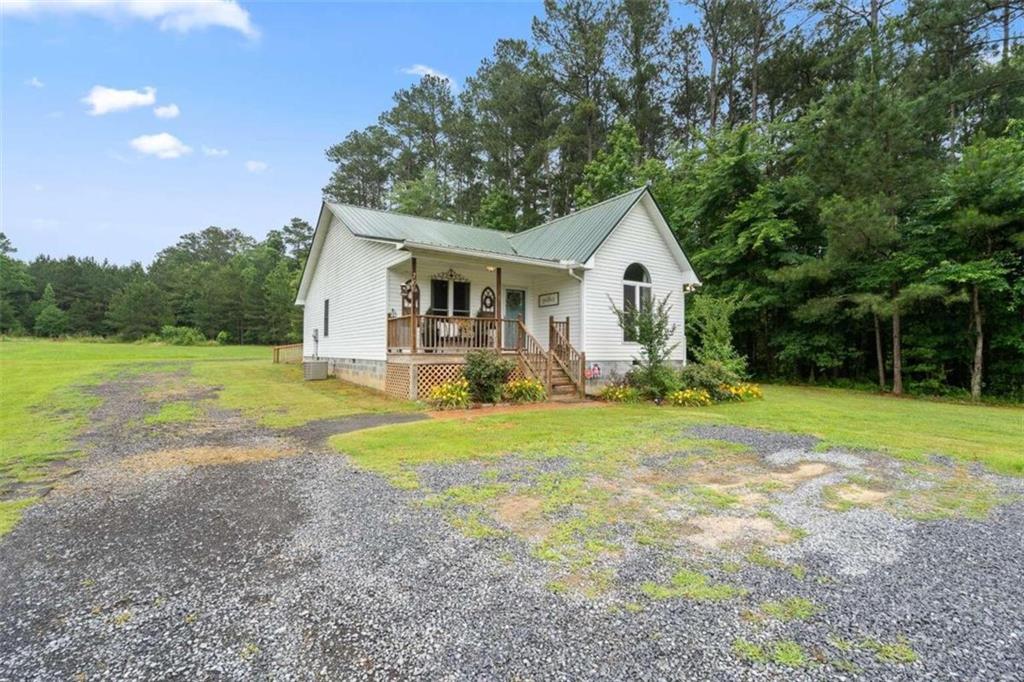 a front view of house with yard and green space