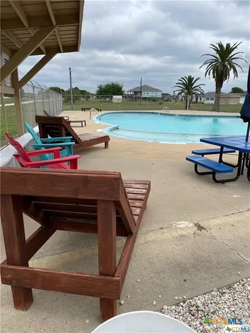 a view of a big house with a big yard and large trees