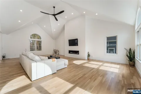 a kitchen with stainless steel appliances kitchen island granite countertop a dining table chairs and white cabinets