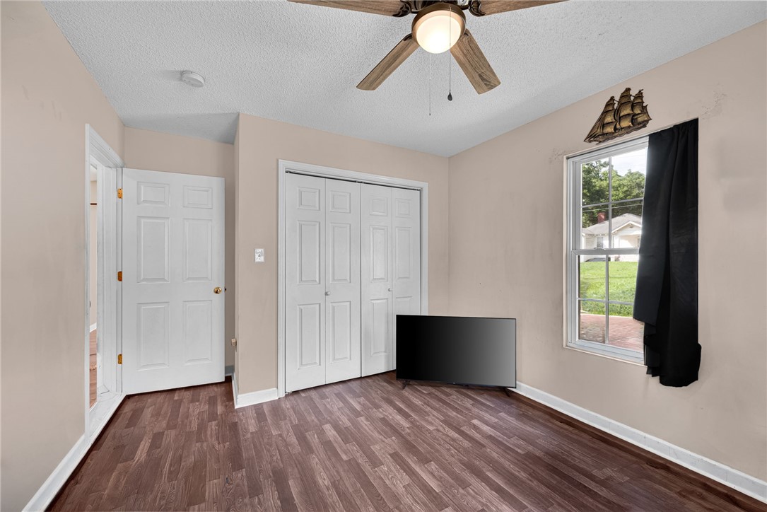 1020 Elizabeth Street Anderson, SC 29624 - Photo 14 of 22 Well-lit sleeping quarters with rich wood-look flooring and a functional ceiling fan for comfort.