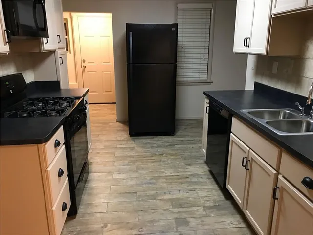 a kitchen with a sink stove and refrigerator