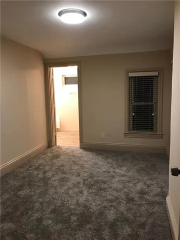 an empty room with a empty space and windows