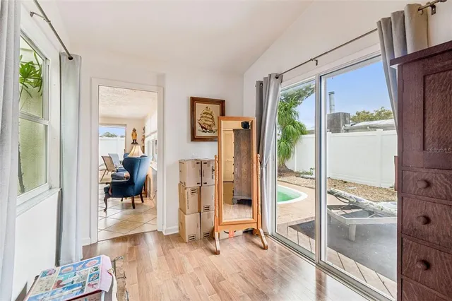 a view of a livingroom with wooden floor and furniture