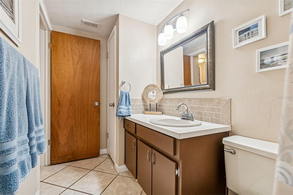 7740 Hawthorn Drive Port Richey, FL 34668 - Photo 13 of 27 a bathroom with a sink and a mirror