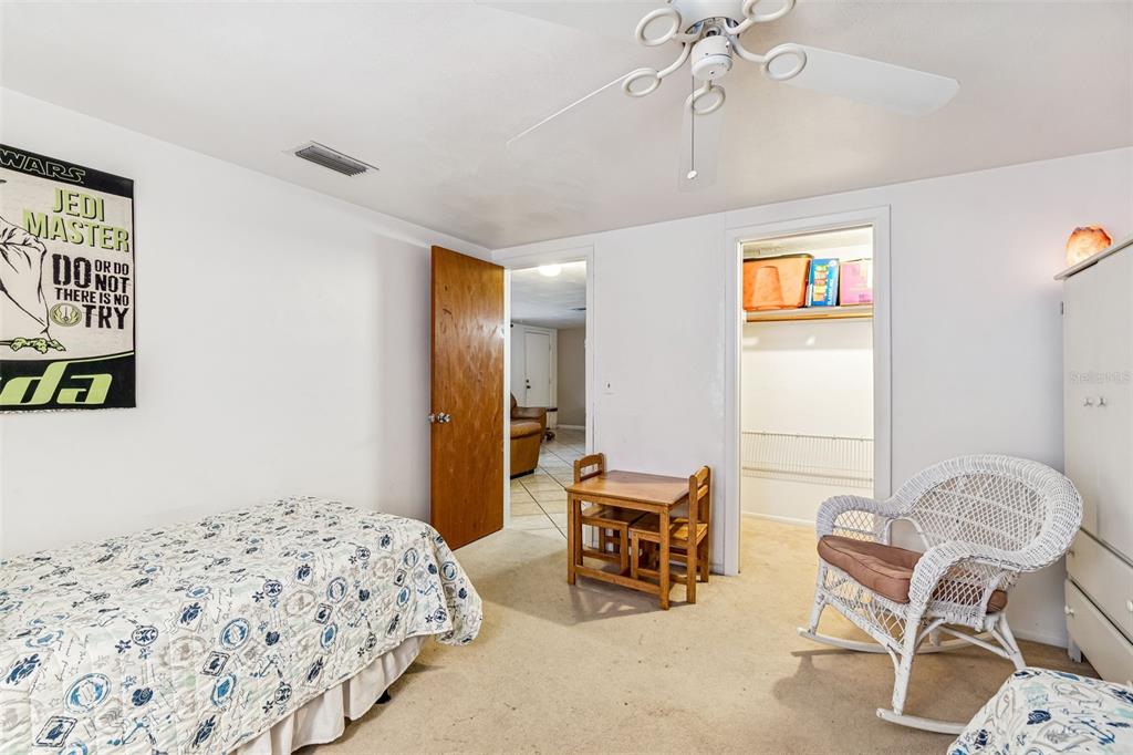 7740 Hawthorn Drive Port Richey, FL 34668 - Photo 18 of 27 a bedroom with furniture and a bed