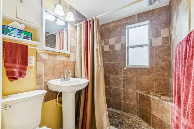 a bathroom with a sink a mirror and a shower