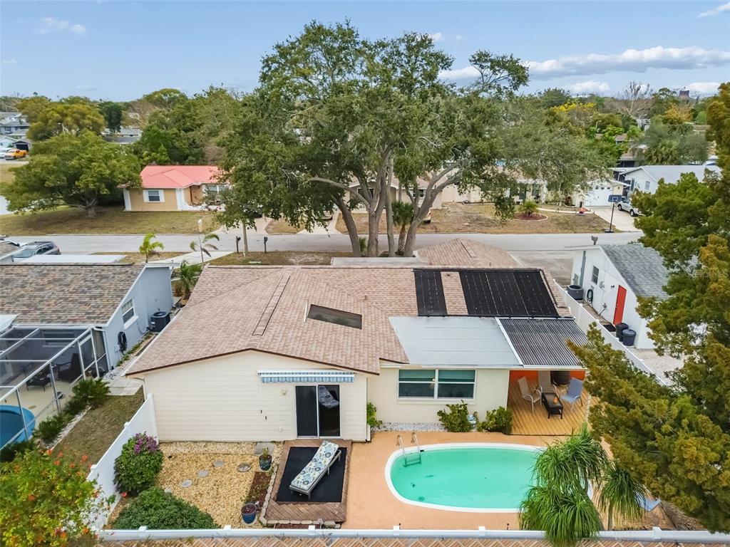 7740 Hawthorn Drive Port Richey, FL 34668 - Photo 2 of 27 an aerial view of a house with a yard and large tree