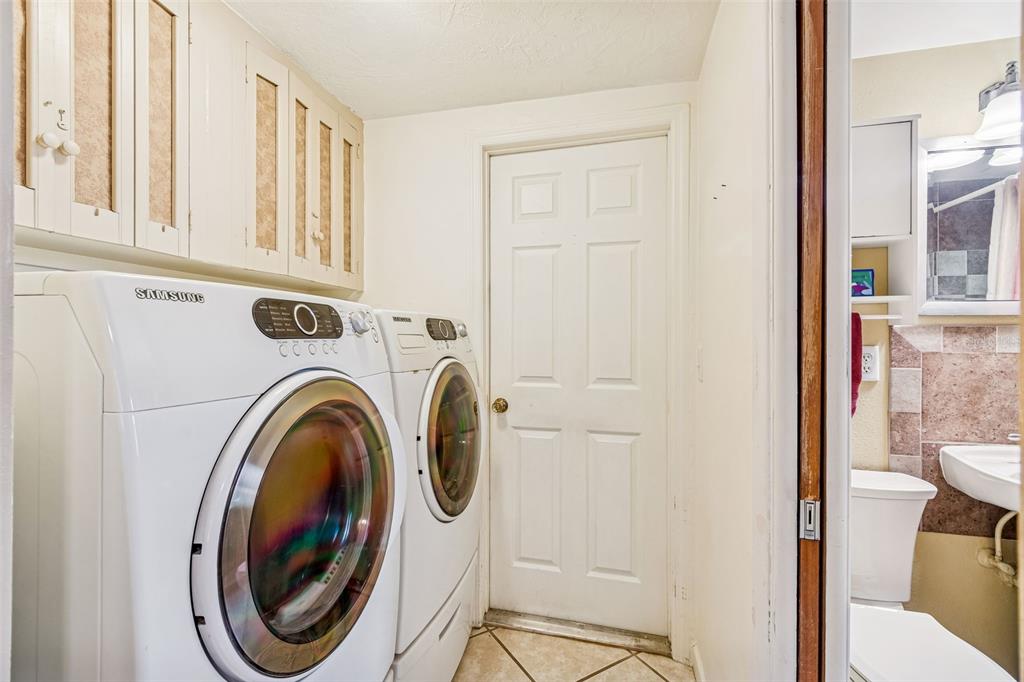 7740 Hawthorn Drive Port Richey, FL 34668 - Photo 22 of 27 a view of a hallway with washer and dryer