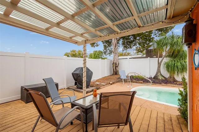 a swimming pool with outdoor seating and yard