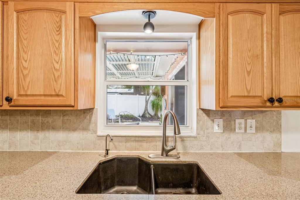 7740 Hawthorn Drive Port Richey, FL 34668 - Photo 9 of 27 a kitchen with a sink and a window