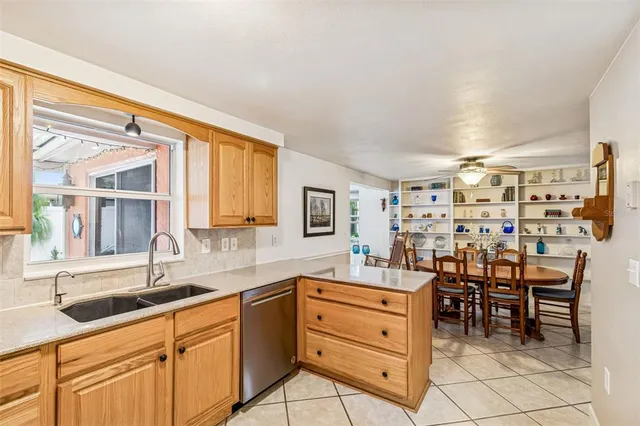 a kitchen with a sink and chairs