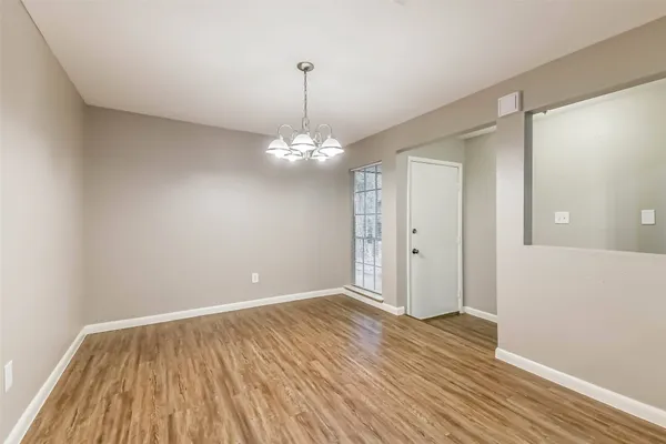 a view of a room with wooden floor and workspace