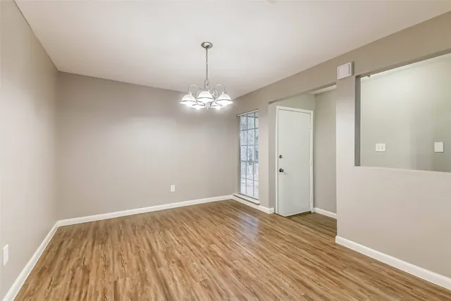 a view of a room with wooden floor and workspace