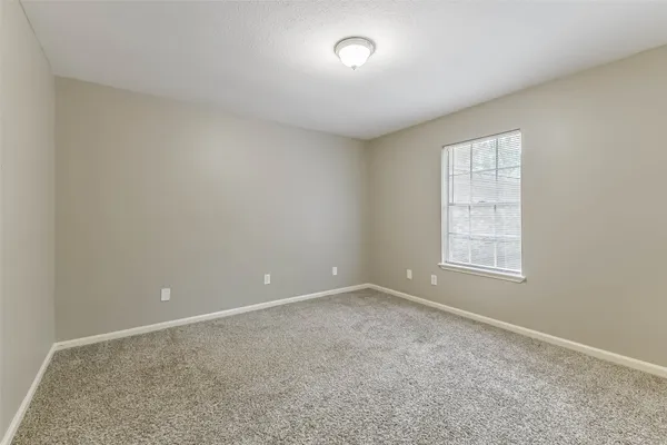 a view of an empty room and closet area