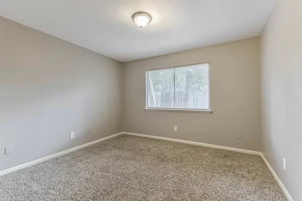 a bathroom with a granite countertop sink a toilet and a mirror