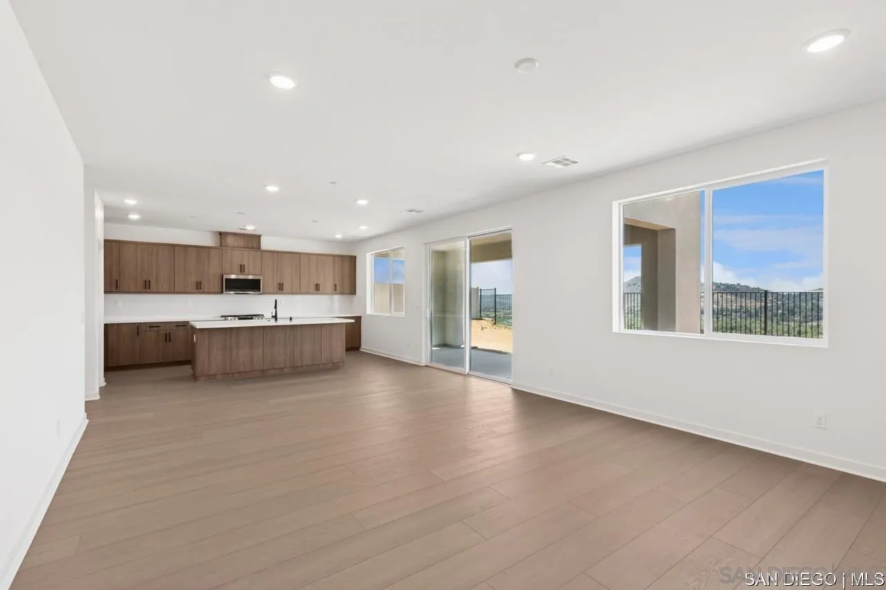 632 Meadowood Street Fallbrook, CA 92028 - Photo 15 of 21 a large white kitchen with a large window