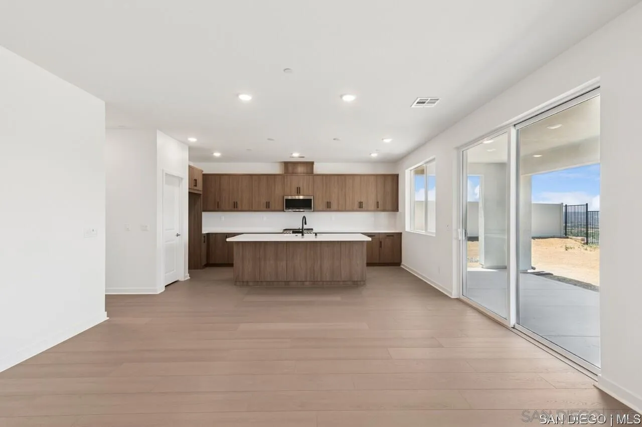 632 Meadowood Street Fallbrook, CA 92028 - Photo 16 of 21 a large kitchen with a large counter top a sink stainless steel appliances and cabinets