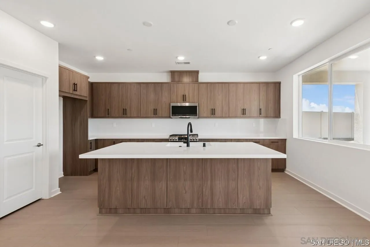 632 Meadowood Street Fallbrook, CA 92028 - Photo 17 of 21 a large kitchen with kitchen island a sink stainless steel appliances and cabinets