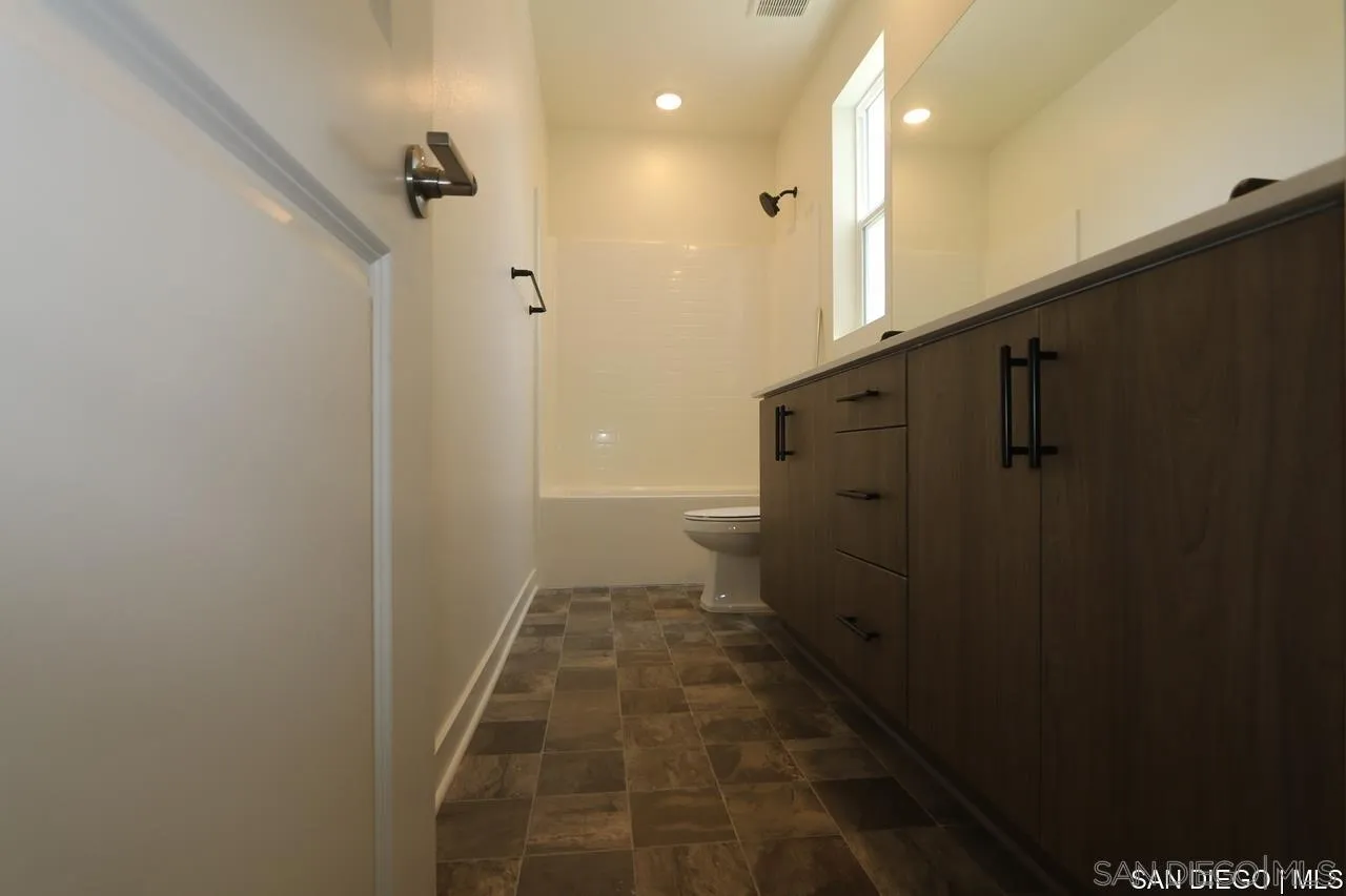 632 Meadowood Street Fallbrook, CA 92028 - Photo 3 of 21 a bathroom with a shower and a toilet