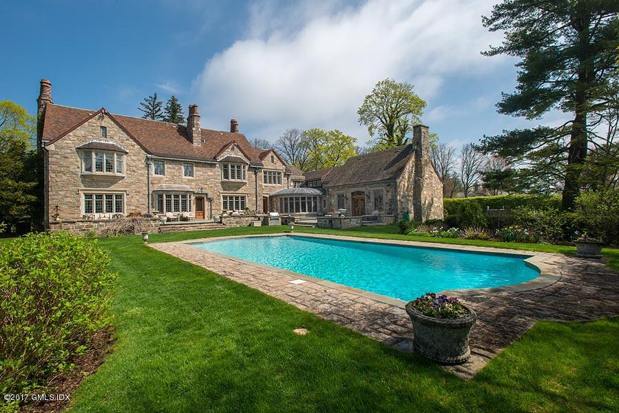 10 Flagler Drive Greenwich, CT 06830 - Photo 14 of 21 a front view of a house with a garden and swimming pool