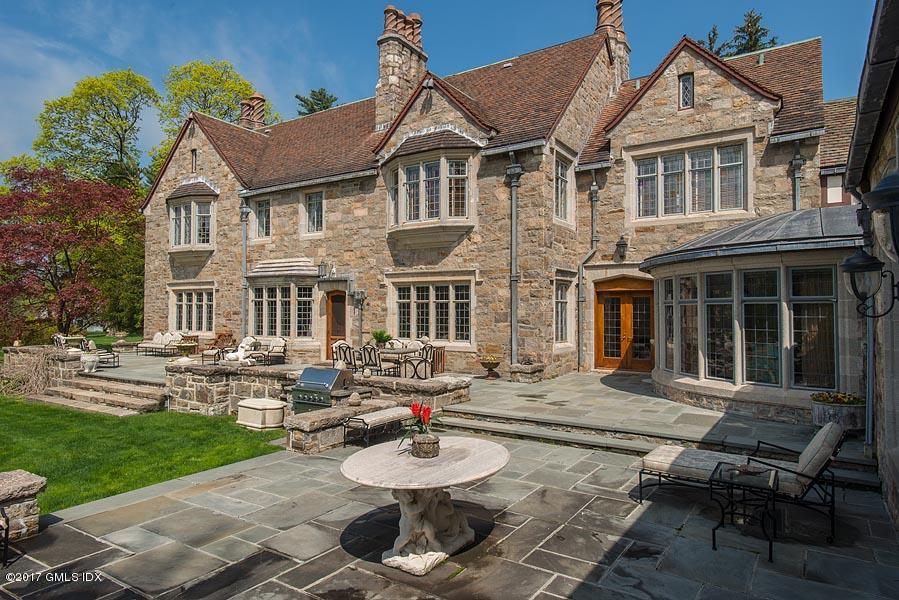 10 Flagler Drive Greenwich, CT 06830 - Photo 17 of 21 a front view of a house with garden and chairs