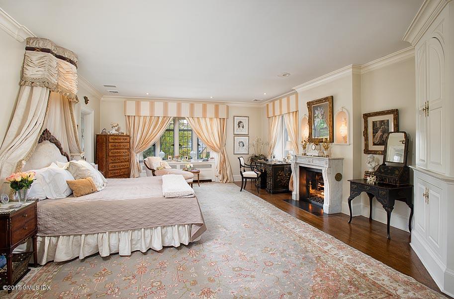10 Flagler Drive Greenwich, CT 06830 - Photo 10 of 21 a bedroom with furniture and a fireplace