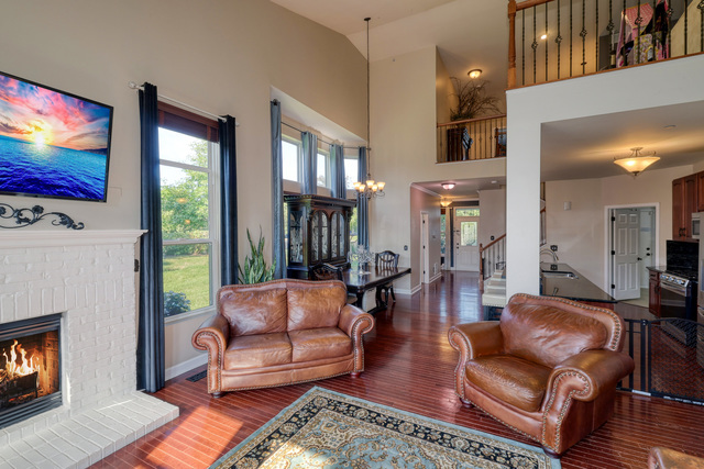 4579 Half Moon Drive, Unit D Yorkville, IL 60560 - Photo 11 of 44 a living room with furniture a flat screen tv and a fireplace