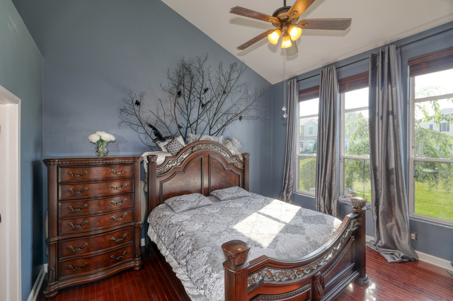 4579 Half Moon Drive, Unit D Yorkville, IL 60560 - Photo 13 of 44 a bedroom with a bed and a chandelier