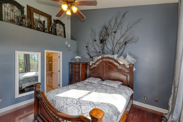 4579 Half Moon Drive, Unit D Yorkville, IL 60560 - Photo 14 of 44 a bedroom with a bed and wooden floor