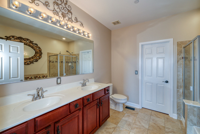 4579 Half Moon Drive, Unit D Yorkville, IL 60560 - Photo 16 of 44 a spacious bathroom with a double vanity sink a toilet and a mirror